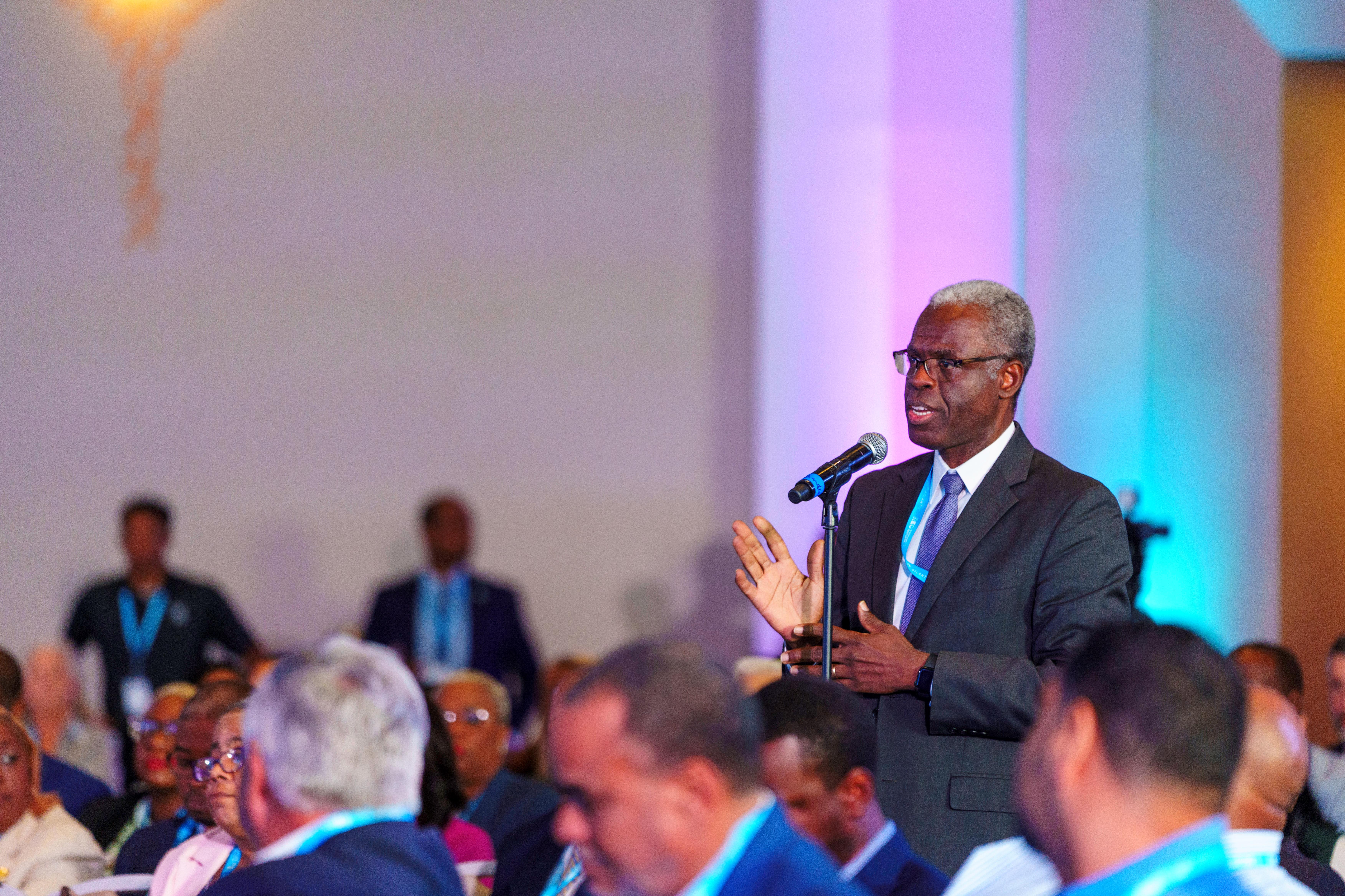 Gov of the Central Bank, John Rolle, asks presenters a question during a keynote.